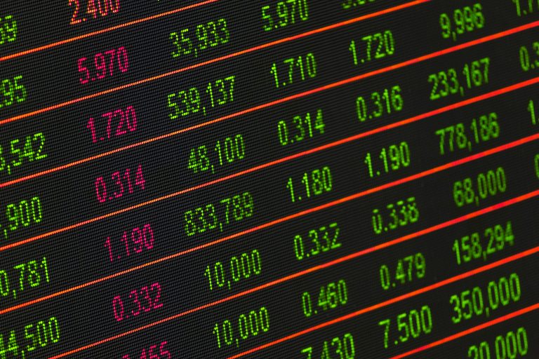 Close-up of a digital stock market data display showing colorful financial numbers and trends.